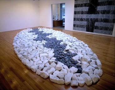 rocks organized in the shape of an oval on the floor