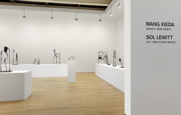 installation view of tables with abstract sculptures