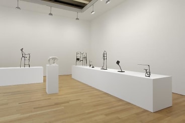 installation view of tables with abstract sculptures
