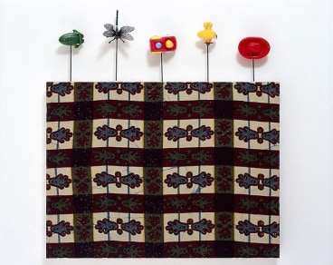 painting on textile with small toys attached to its borders