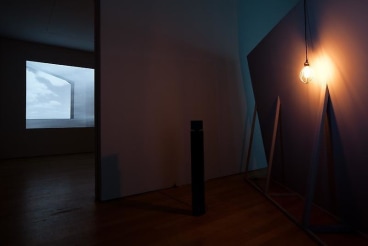 light hanging from back of video projection