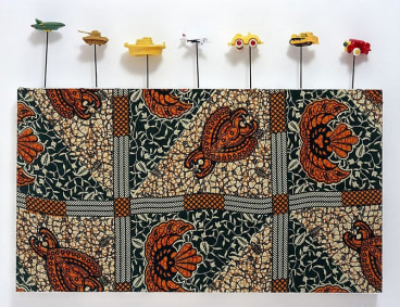 painting on textile with small toys attached to its borders