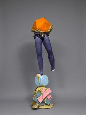 a pair of legs balancing themselves on one foot on a giant dice