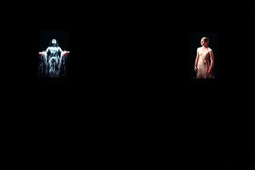 installation view of several videos in a dark room