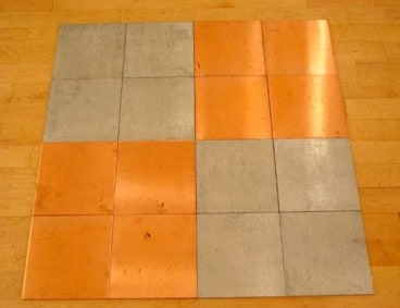 copper and zinc square tiles on the floor