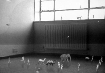 tiny animals and people walking all over a room