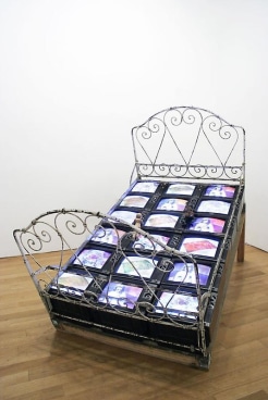 tiled bed with mattress comprised of televisions