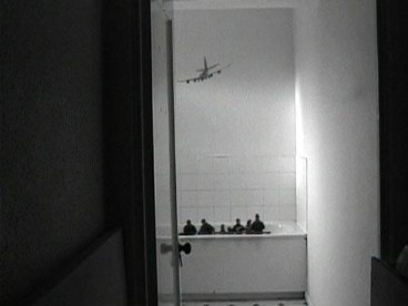 tiny airplane flying towards a bathroom