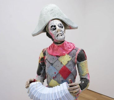 close up of statue with an accordion
