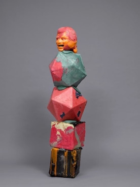 an orange head balancing itself on geometric shapes
