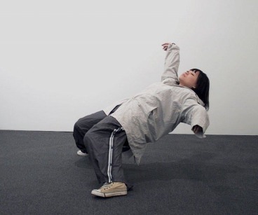 A female figure bending backwards, suspended in space