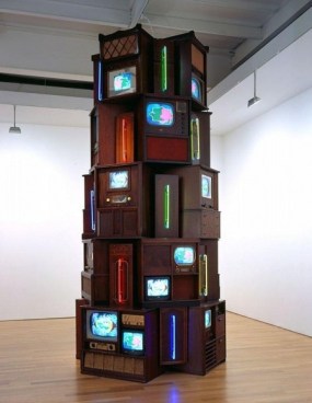 Tower of televisions of various sizes, from many eras