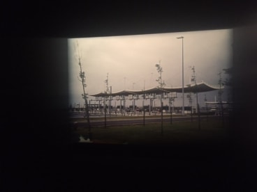 A PHOTOGRAPH OF A TOLLBOOTH HUNG ON A DARKLY PAINTED WALL, THE BLEAK REPRESENTATION OF SUBURBAN FRANCE AT &quot;MICHEL HOUELLEBECQ: FRENCH BASHING.&quot; THE AUTHOR&#039;S FIRST ART SHOW IN THE US OPENED ON FRIDAY IN NEW YORK.