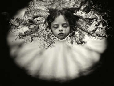 A black and white image of a child sleeping 