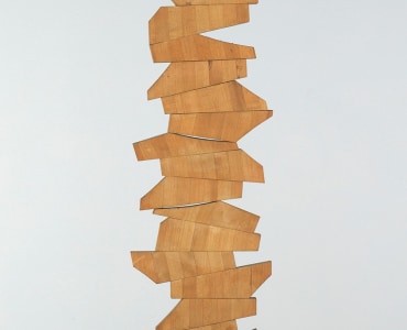 A wooden sculpture of piled geometric shapes