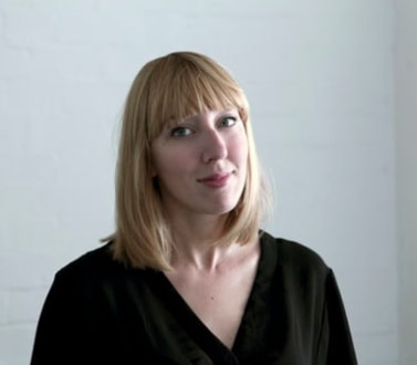 blonde, white woman wearing a black shirt