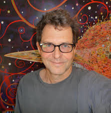 Fred Tomaselli standing in front of one of his artworks