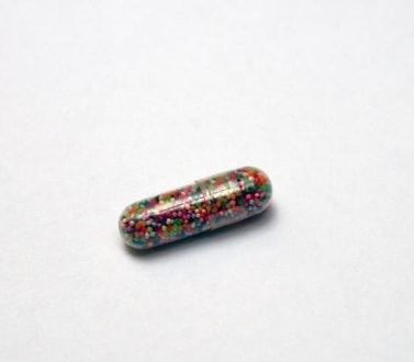 pill with colorful beads inside 