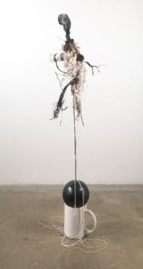 How many cups does it take to make a continuum suspend: stress, 2011. Large coffee cup, bowling ball, steel rod, melted tennis ball, border bottle, string, scrap tire tread, Rousseau, small coffee cup, 69 1/2 x 28 x 20 inches (176.5 x 71.1 x 50.8 cm). MP 24