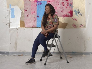 This is an image of the artist Tomashi Jackson in her studio taken by photographer Julia Featheringill.