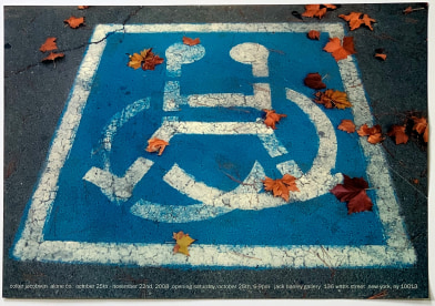 Photo of handicap parking spot, with fall leaves over top