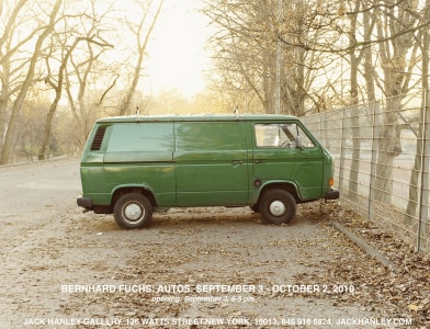 Image of Green van parked among barren trees