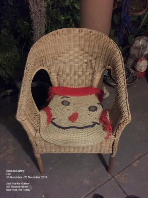 Wicker chair, with face shaped rug overtop
