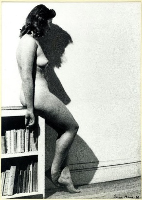 Dora Maar - Assia&mdash;Profile Posing Naked Sitting on the Edge of a Library, 1938 Gelatin silver print mounted to board, printed c. 1938 | Bruce Silverstein Gallery