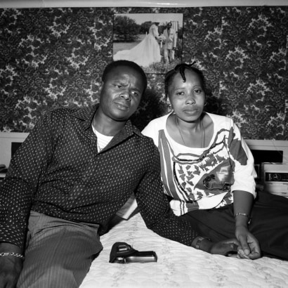 Couple with their wedding picture and their gun, Soweto, South Africa, 1988