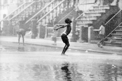 Chester Higgins -  Water spray dancer, Harlem, 1969