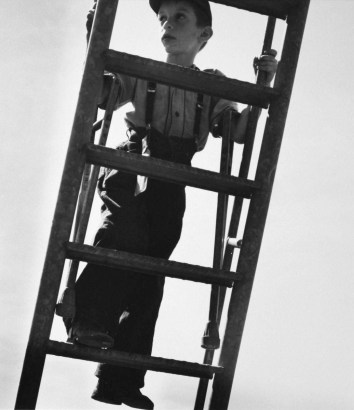 Larry Silver - Boy With Crutches Climbing Ladder, 1950 Gelatin silver print, printed later | Bruce Silverstein Gallery