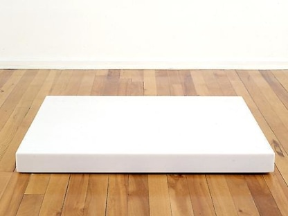 Large white block on a wooden floor