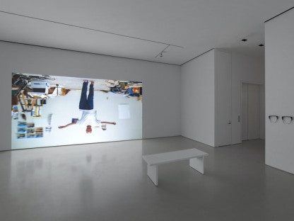 gallery view showing a projection of an upside down man walking with his arms outstretched