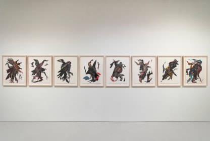 Eight unique and vibrantly colored textile collages hung parallel, each evoking single moving figures, perhaps dancing.