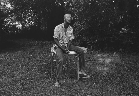 Mark Steinmetz,&nbsp;Knoxville, TN (man sitting on table),&nbsp;1991.&nbsp;Gelatin silver print, 20 x 24 inches.