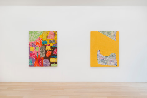 installation view of paintings in a white room