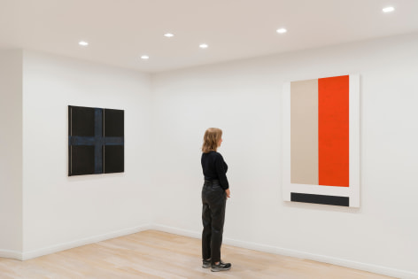 installation view of paintings in a white room