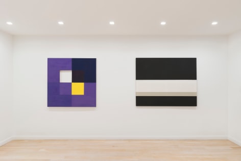 installation view of paintings in a white room