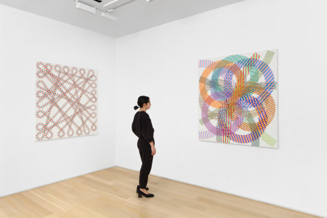 installation view of paintings in a white room