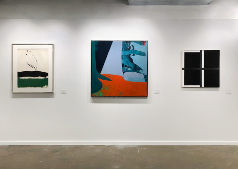 installation view of paintings in a white room