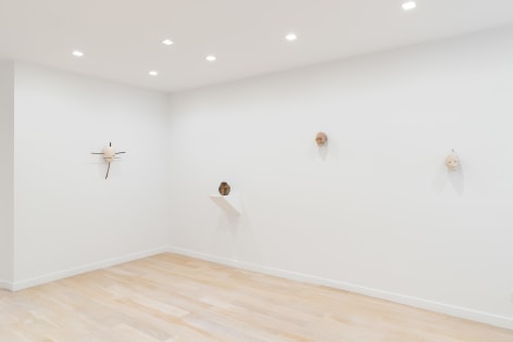 installation view of a white gallery with various sculptures