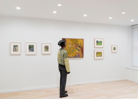 installation view of paintings in a white room