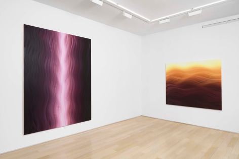 installation view of paintings in a white room