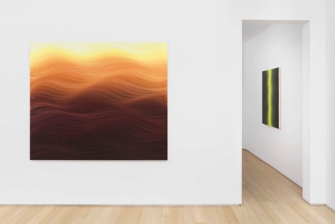 installation view of paintings in a white room