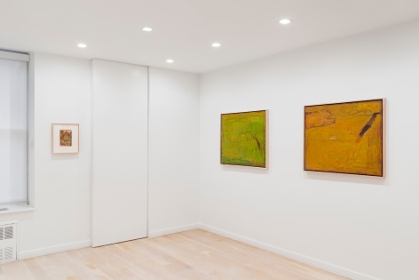 installation view of paintings in a white room