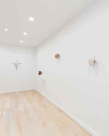 installation view of a white gallery with various sculptures