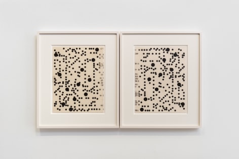 installation view of multiple works on paper in a white room