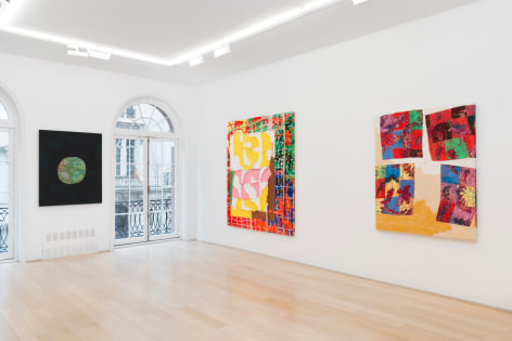 installation view of paintings in a white room