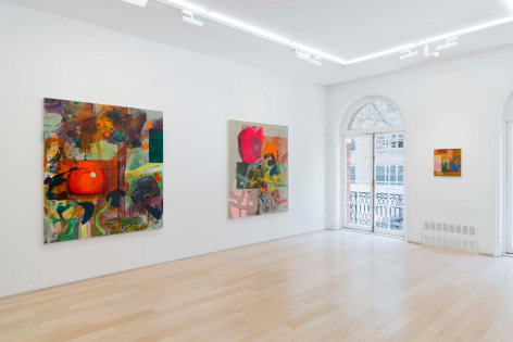 installation view of paintings in a white room