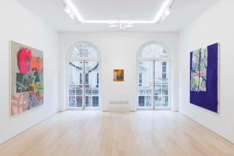 installation view of paintings in a white room